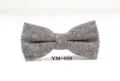Detail view of a classic black and white tweed bow tie for men, stylish and elegant. - YM-010