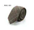 Wool plaid tie detail view, classic tweed fabric texture, elegant formal business accessory. - WOOL-001