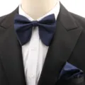 Detail shot of dark blue bow tie and pocket square set, elegant wedding suit accessory. - Navy Blue