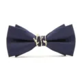 Close-up of navy blue striped bow tie with gold leaf metal ring detail, elegant formal accessory - Navy Blue