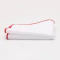 Close-up detail of a classic white men's pocket square featuring a stylish red rolled edge. - Red Border