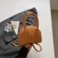 Chic orange faux leather top handle bowling bag with shoulder strap for women daily fashion style. - No Pendant / Brown