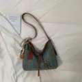Woven straw shoulder bag for women, stylish crossbody bucket bag with tassels and pu trim. - With Pendant / Blue
