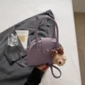 Purple leather bowling handbag for women with cute plush bear pendant, stylish crossbody pillow bag. - With Pendant / Purple