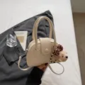 Chic PU leather bowling handbag for women with cute teddy bear charm and crossbody strap. - With Pendant / White