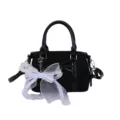 Black top handle handbag for women with white bow charm, stylish leather shoulder bag. - With Pendant / Black