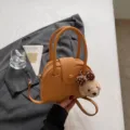 Chic yellow dome bowling handbag for women, stylish top handle versatile crossbody pillow bag. - With Pendant / Brown