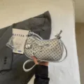 Silver polka dot shoulder bag with bow charm and stylish metallic finish for women. - With Pendant / Silver