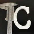 Detailed view of white wooden letter C, perfect for home wedding decor and photography props. - White Letter C