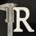 White wooden letter R ornament detail shot, perfect for home decor and wedding displays. - White Letter R