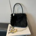 Chic black faux fur handbag with elegant pearl handle and golden chain strap for women. - Black