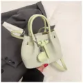 Fashion green woven bucket bag stylish leather handbag with shoulder strap and lock charm - With Pendant / Green