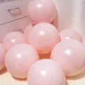 Close-up detail of soft macaron pink latex balloons piled together for celebration scene decor - Macaron Pink