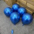 Metallic blue latex balloons displayed in warehouse setting, perfect for party decor details. - Metallic Blue