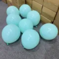 Close-up detail of light blue latex balloons arranged on floor for party decoration scene. - Macaron Tiffany Blue