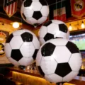 Soccer football shaped foil balloons for sports theme party bar decor and birthday celebrations. - 5-Piece 4D Football Set with Pump and Ribbon
