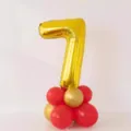 Gold number 7 foil balloon with red and gold latex balloons base for birthday party decor. - Gold Number 7 Balloon Column with Glue Dots and Ribbon