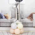 Silver number 1 foil balloon with pastel latex balloon base for birthday party decoration. - 40 Inch Silver Aluminum Foil Number Balloon 1