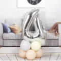 Silver number 4 foil balloon with pastel balloon base for birthday party and celebration decor. - 40 Inch Silver Aluminum Foil Number Balloon 4