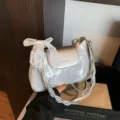 Silver metallic shoulder bag for women, stylish braided strap with cute white lace bow. - Silver