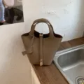 Stylish leather bucket handbag for women, casual tote bag with top handles and lock detail. - No Pendant / Khaki