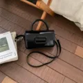 Black patent leather top-handle crossbody bag with modern square buckle, stylish. - No Pendant / Black