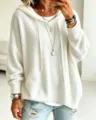 Close-up detail of the white knitted hooded sweater featuring cozy drawstring and ribbed hem. - S / White