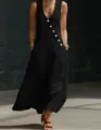 Detail view of a chic black sleeveless V-neck maxi dress featuring stylish diagonal buttons. - S / Black