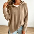 Close-up detail of women's khaki knit hoodie sweater, featuring long sleeves and drawstrings. - Khaki