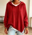 Close-up detail of cozy red knit hooded sweater, showing soft texture and drawstring. - S / Red