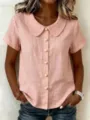 Detailed view of women pink short sleeve Peter Pan cotton shirt with pearl buttons. - Pink