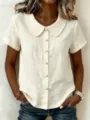 Close-up of women's short-sleeve linen shirt with Peter Pan collar and pearl buttons. - S / Apricot