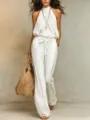 Detail shot of a white halter neck jumpsuit featuring a chic cinched waist and wide leg. - S / White