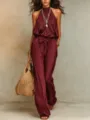 Burgundy halter jumpsuit detail, stylish sleeveless resort wear with tie waist and wide legs. - S / Burgundy