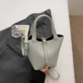 Light blue soft leather bucket bag with lock closure and shoulder strap for women daily use. - No Pendant / Blue
