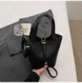 Black leather bucket bag with top handles and shoulder strap, stylish daily commuter handbag. - No Pendant / Black