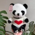 Close-up detail shot of cute panda plush toy wearing white knit sweater with red heart. - Panda with Red Heart / 25cm