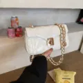 Chic white quilted chain shoulder bag for women, stylish crossbody mini bag variant. - White