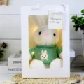 Cute plush rabbit toy in white gift bag with green sweater and warm fairy lights for kids. - White Rabbit in Green Clothes Gift Box / 30cm