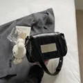 Black textured shoulder bag for women, chic chain strap and cute plush bunny charm design. - Black with Charm