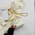 White quilted chain crossbody bag with elegant gold camellia flower emblem and top handle. - Rice White Small