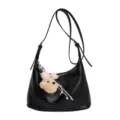 Black leather shoulder hobo bag for women with cute plush bear pendant and bow accessory. - With Charm / Black