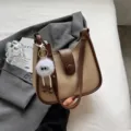 Chic contrast color shoulder bag for women, stylish bucket handbag with cute keychain decor. - With Pendant / White & Coffee