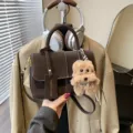 Dark brown vintage matte crossbody bag with cute plush dog keychain and white stitching details. - Brown with Pendant