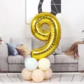 Gold number 9 foil balloon birthday party decoration backdrop for home celebration. - Number 9 / Gold
