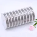 Detail shot of multiple rolls of steel beading wire for DIY jewelry making and crafting. - 0.45mm, Approx. 26m per Roll / Natural