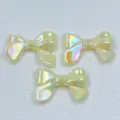 Close-up detail of iridescent acrylic bow charms, macaron color DIY jewelry making beads. - 24*32mm / Yellow