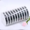 Detail view of black beading thread on white spools, neat plastic wrap packaging. - 0.45mm, Approx. 26m per Roll / Black