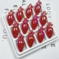 Close-up detail of shiny red acrylic carrot beads, perfect for DIY jewelry and craft projects. - Red