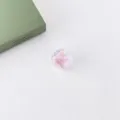 Detailed close-up of acrylic heart-core UV coated diamond-cut loose beads for DIY crafts. - Pink